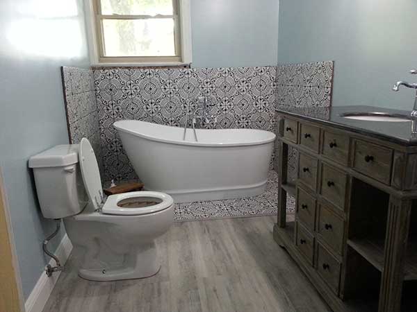 Bathroom remodel after new sheetrock and trim done by Repair Masters.