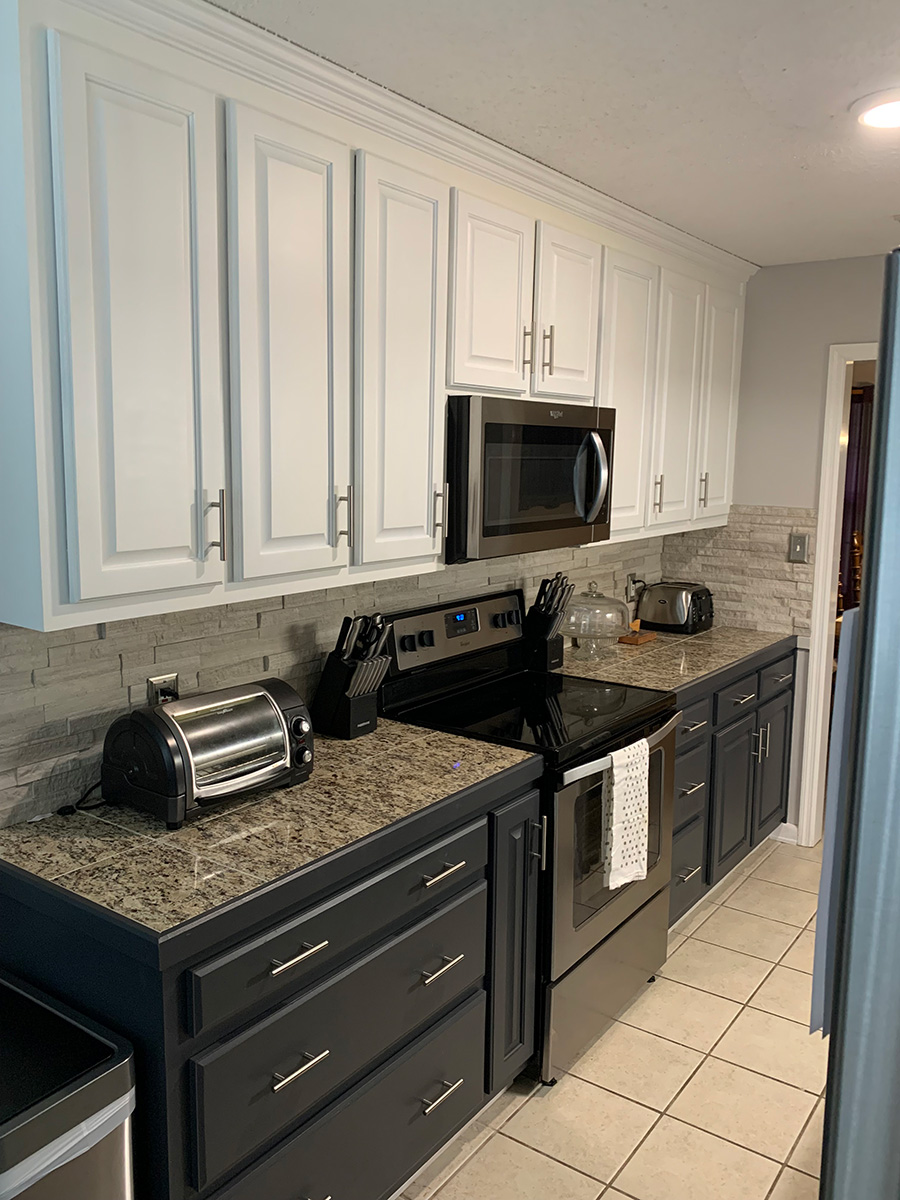 Kitchen Remodel with white cabinets and black drawers.